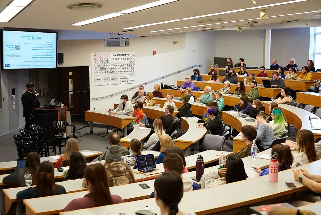 Students in a lecture hall listening to a speaker at a Climate Teach-In event